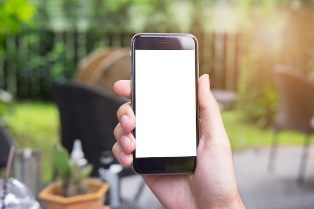 Close up of a man hand holding smart phone with blank screen mobile in gargen.