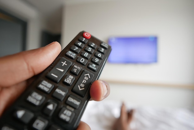 Close up of man hand holding tv remote