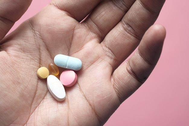 Close up of man hand taking medicine .