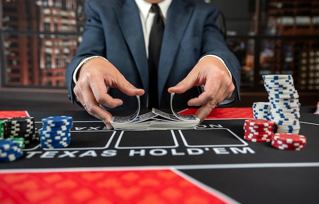 close up man hand with poker card at casino table