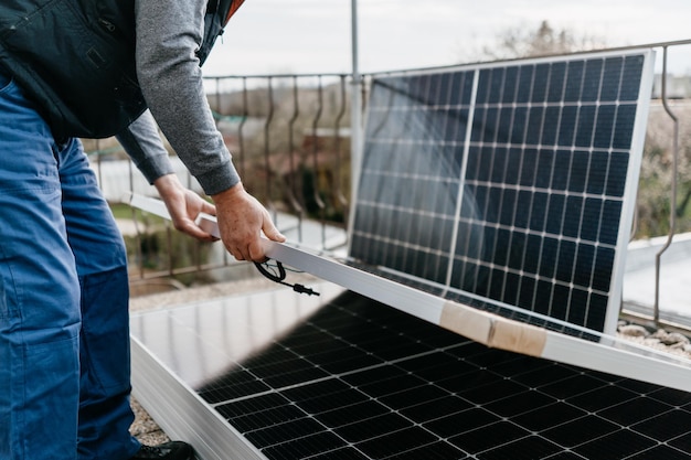 Close up of man holding solar panel Eco concept alternative energy