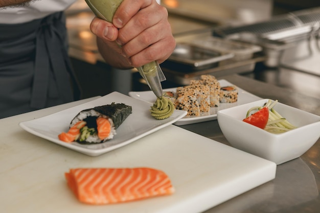 Close up of man japanese restaurant chef cooking sushi in the kitchen