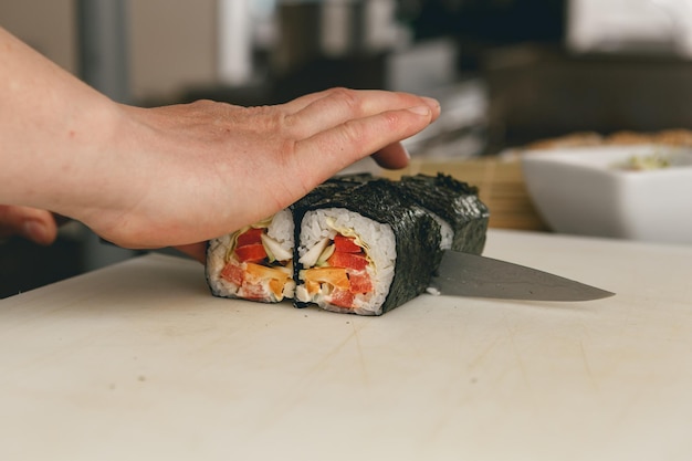 Close up of man japanese restaurant chef cooking sushi in the kitchen