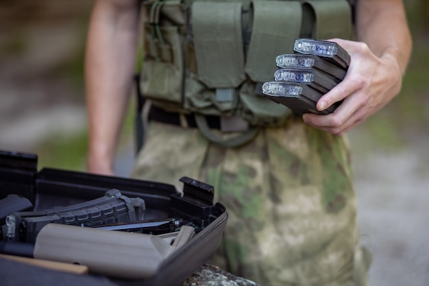 Close up of a man preparing for the airsoft game in military uniform