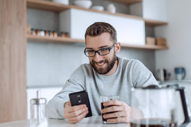 Close up man reading emails during breakfast