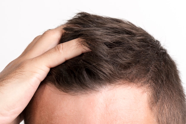 Close-up of man's hand touching his hair