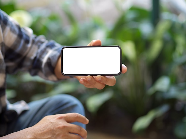 Close up on a man showing smartphone screen to camera