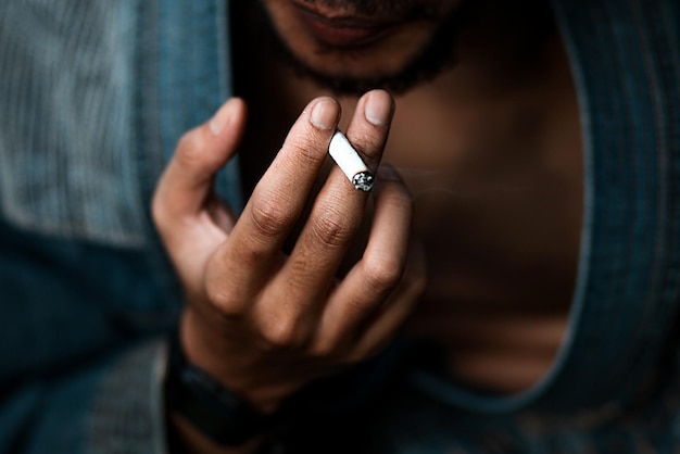 Close up man smoking a cigarette