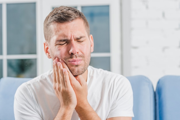 Close-up of a man suffering from toothache