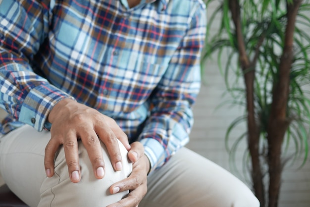 Close up on man suffering knee joint pain