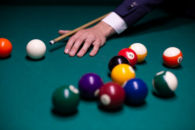 Close-up man in suit playing billiard 