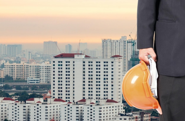 Close up of man in suit with construction helmet