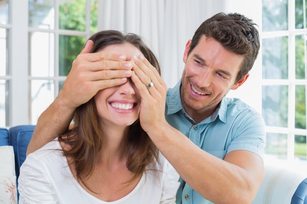 Close-up of a man surprising woman at home