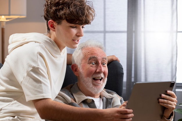 Close up man and teenager with tablet