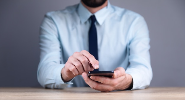 Close up of a man using mobile smart phone
