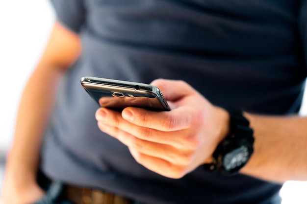 Close up of a man using mobile smart phone