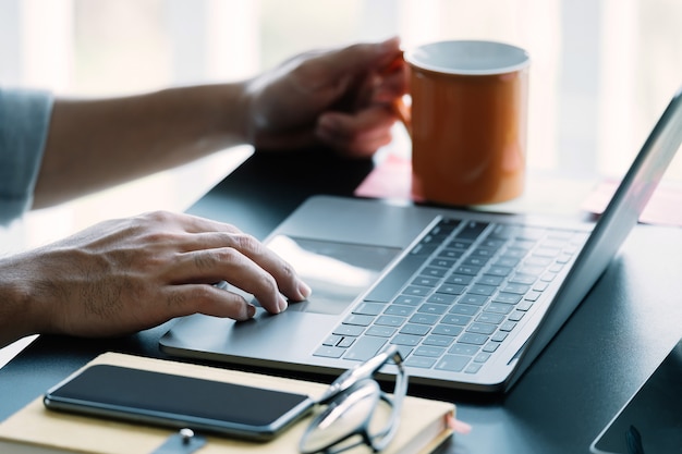 Close up man using smart laptop at home