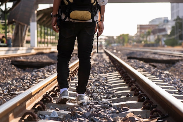 Close up of a man walking along the railway Without destination