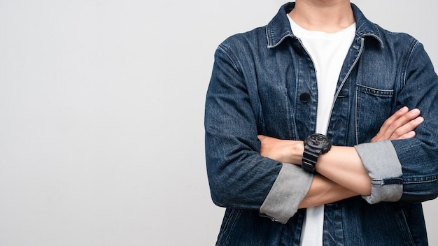 Close up man wear jeans shirt with watch arms crossed studio shot isolated