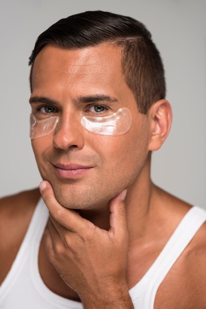 Close-up man with under eye patches