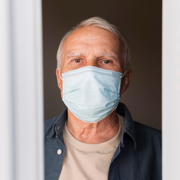 Close-up man with mask indoors