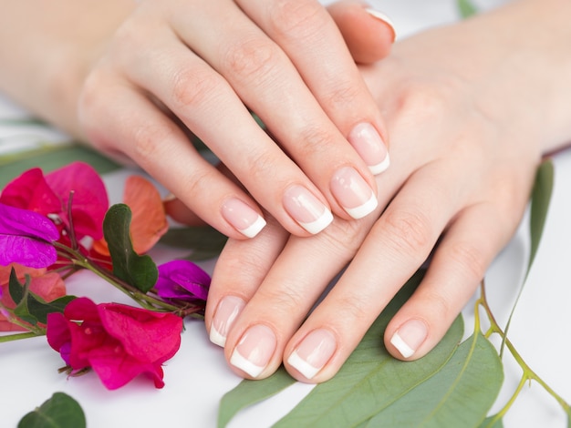 Close up manicured hands and flowers