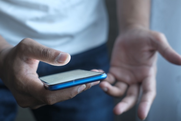 Close up of mans hand using smart phone at night