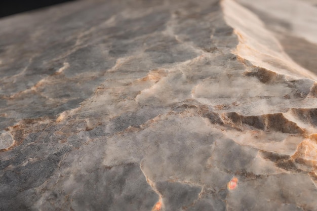 A close up of a marble table with a white and brown marble top.