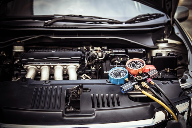 Close up measuring manifold gauge for mechanic check the refrigerant and filling car air conditioner for fix and checking for repair service support maintenance and car insurance