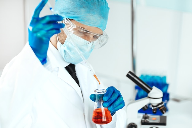 Close up. medical flask in the hands of the researcher