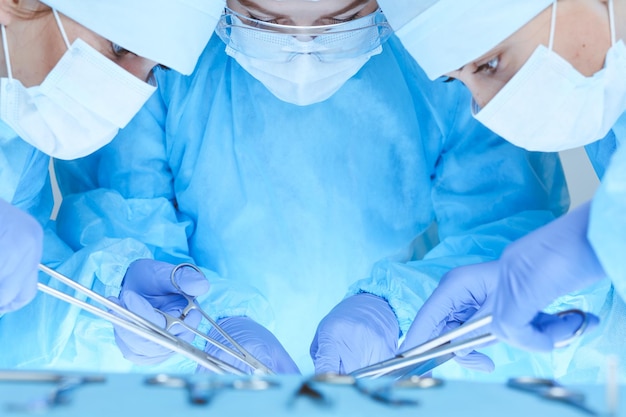 Close-up of medical team performing operation. Group of surgeons at work are busy of patient. Medicine, veterinary or healthcare and emergency in hospital.