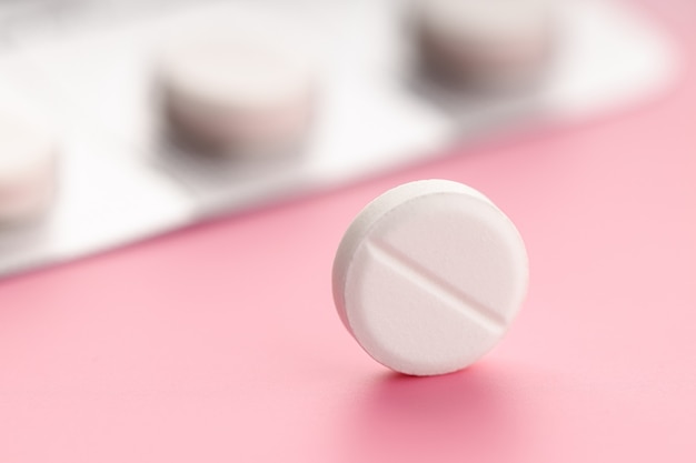 Close up of Medicine pill on pink background. Medicine, healthcare and pharmacy concept