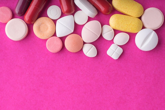 Close-up of medicines over pink background