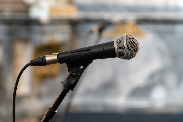 Close up of microphone in concert hall or conference room isolated