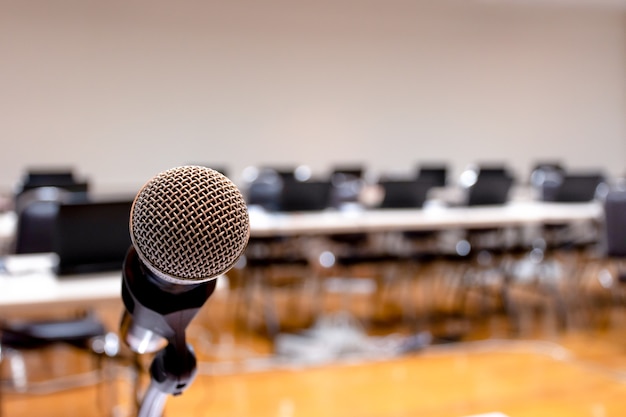 Close up microphone with laptop on table background in seminar room