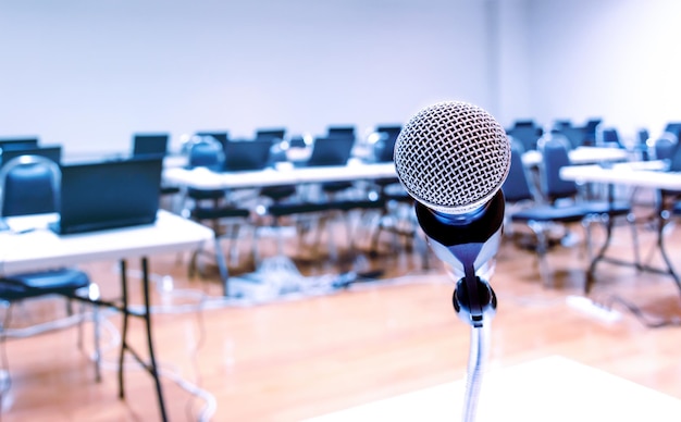 Close up microphone with laptop on table background in seminar room