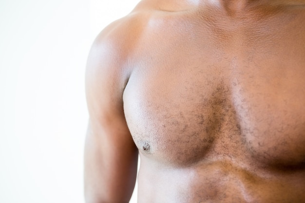 Close-up mid section of shirtless muscular man