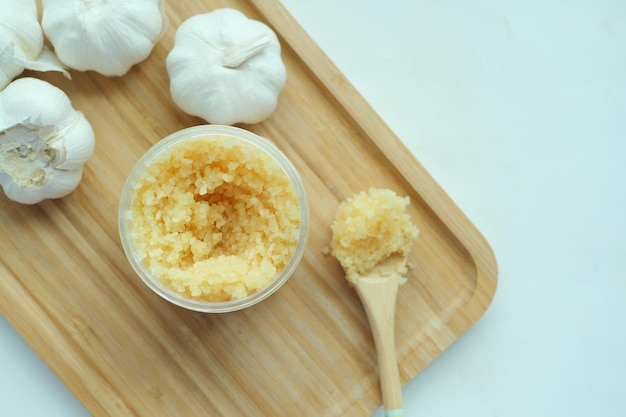 Close up of minced garlic on a wooden spoon