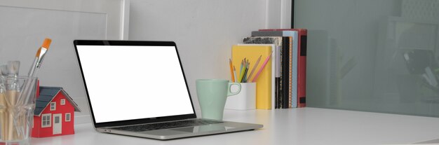 Close up of a minimal home office with laptop and desk