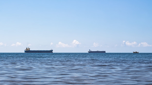 Close-up of a minimalistic seascape on a bright summer day. Blue sea, clouds over the horizon