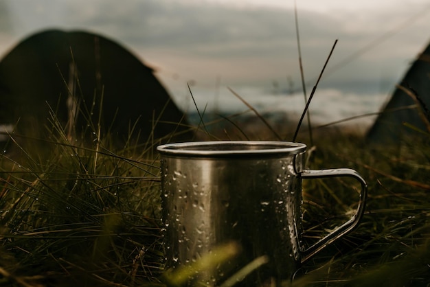 Close up mockup of metal tourist mug in mountain camp