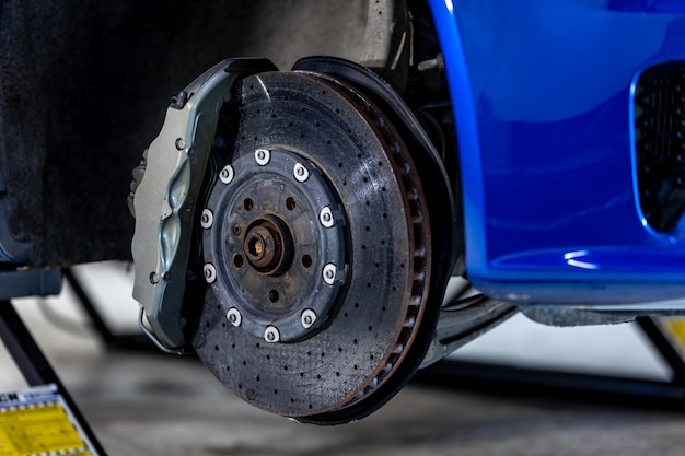 Photo close up of a modern car brakes during maintenance repair transport concept