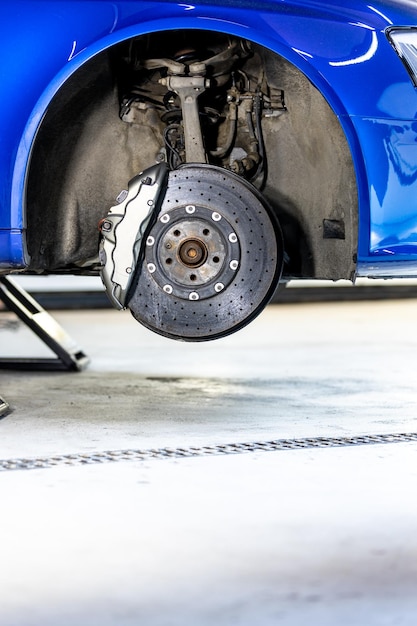 Close up of a modern car brakes during maintenance repair transport concept