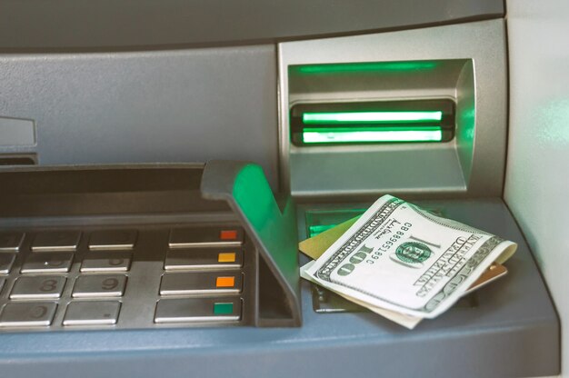 Close-up of money with a bank card lie on the ATM.