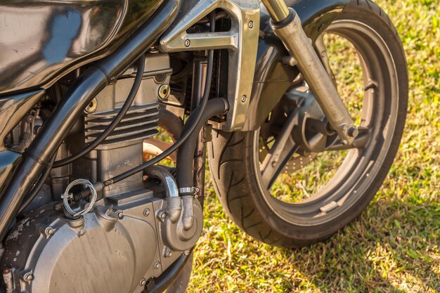 Close-up of motorcycle on grass