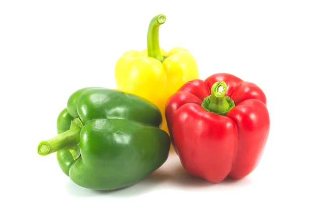 Close-up of multi colored bell peppers against white background