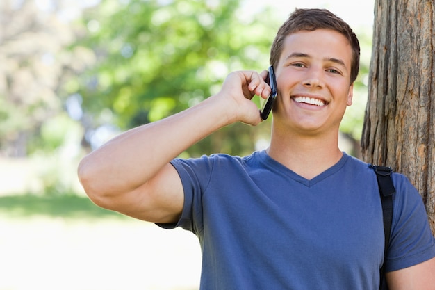 Close-up of a muscled young man on the phone