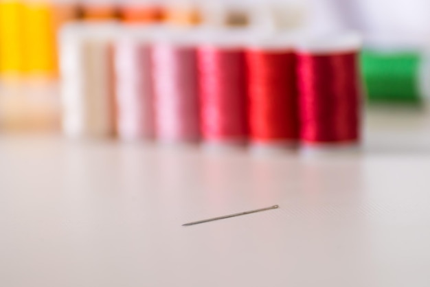 close-up of needle and back threads, dressmaker, atelier, seamstress, sewing clothes, embroidering a