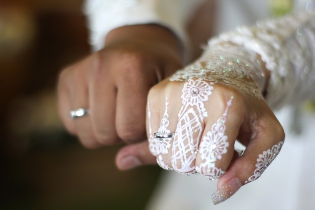 Close up of new married couples hands showing their wedding rings