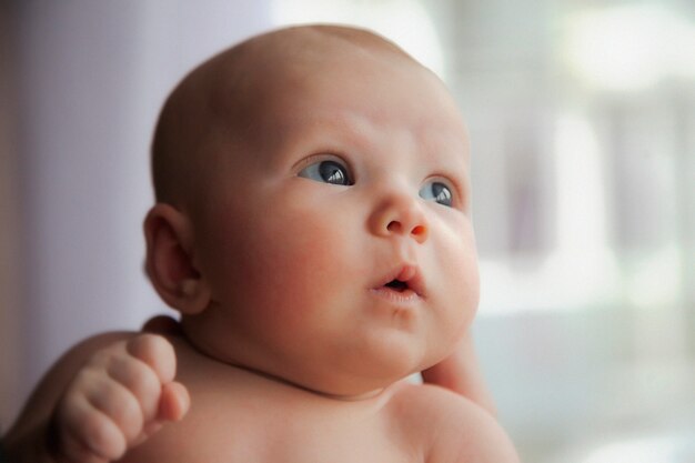 Close-up of newborn's head in father's hand.